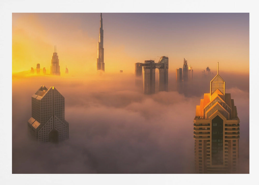 An aerial photograph of the Dubai skyline shrouded in a thick blanket of fog at sunrise. The warm golden light illuminates the tops of several skyscrapers, including the Burj Khalifa, which pierce through the clouds creating a dreamlike and majestic scene. Print