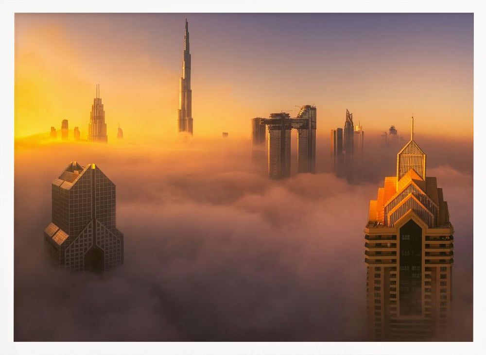 An aerial photograph of the Dubai skyline shrouded in a thick blanket of fog at sunrise. The warm golden light illuminates the tops of several skyscrapers, including the Burj Khalifa, which pierce through the clouds creating a dreamlike and majestic scene. Print