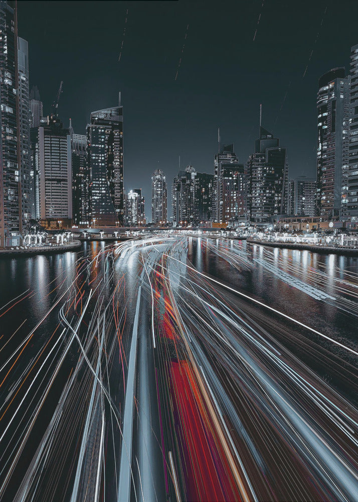 A dynamic long-exposure photograph of a bustling city marina at night. In the foreground, vibrant streaks of red and white light from moving boats cut across the dark water. In the background, a modern skyline of illuminated skyscrapers stands against a dark night sky, creating a futuristic and energetic scene. Poster