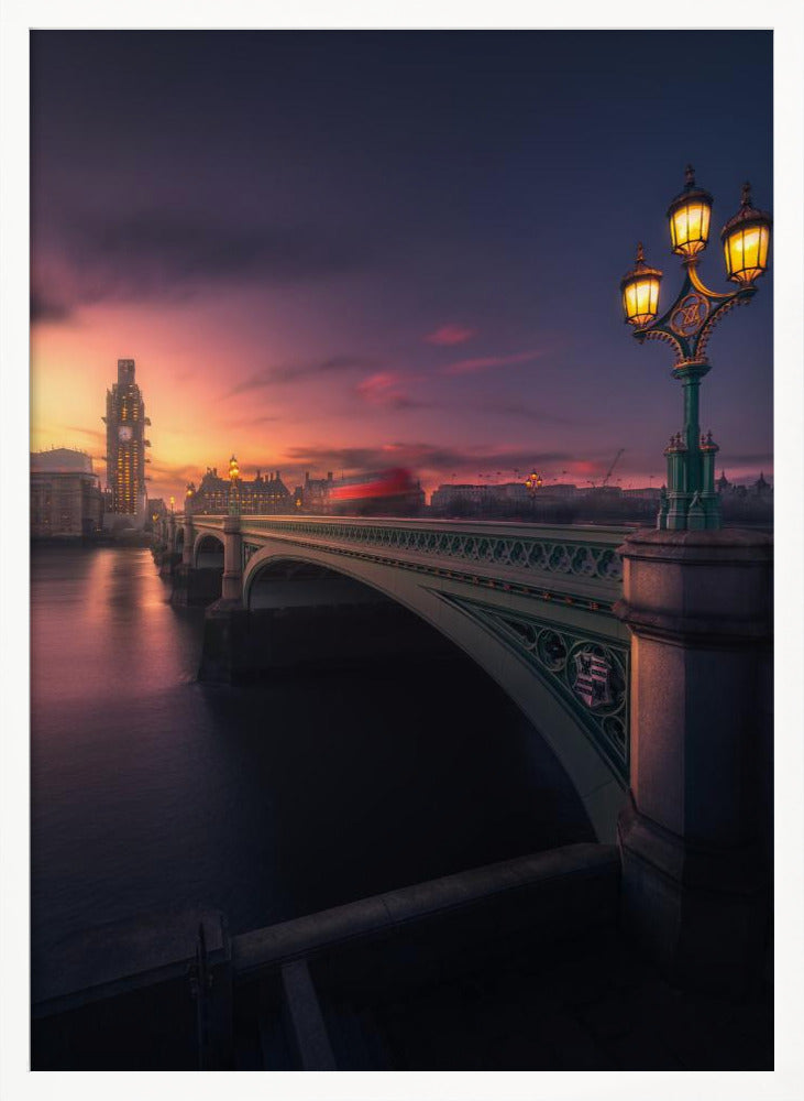 A breathtaking twilight view of Westminster Bridge in London, with the iconic Big Ben illuminated in the background against a purple and orange sunset sky. A vintage street lamp glows warmly in the foreground, and the motion blur of a red bus crosses the bridge over the calm River Thames. Print