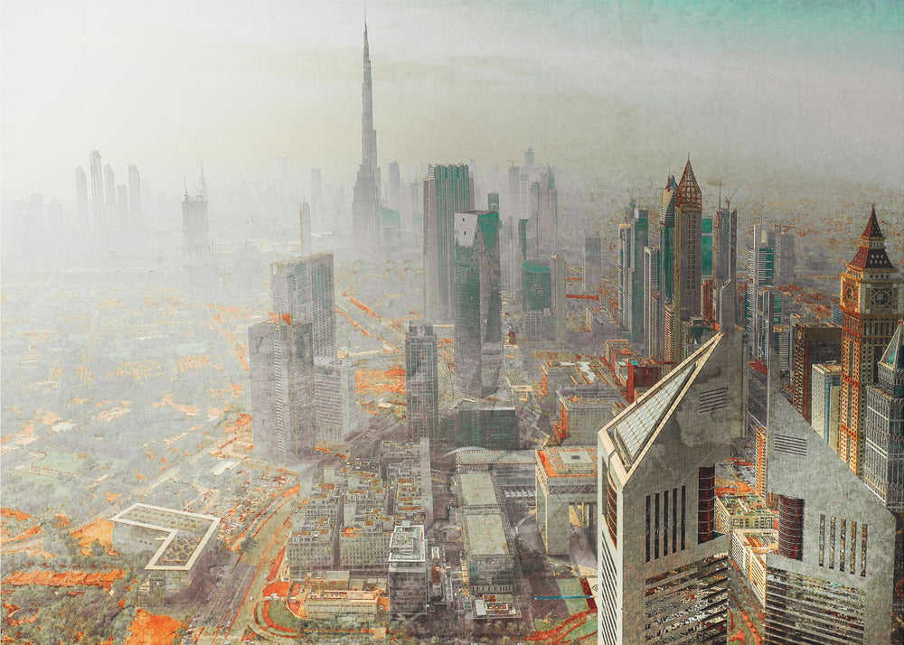 A framed piece of art showing a hazy, high-angle view of the Dubai skyline, with the Burj Khalifa towering in the background. The cityscape is rendered in muted tones of grey and teal, with striking orange accents on the ground, creating a surreal, artistic effect. Print
