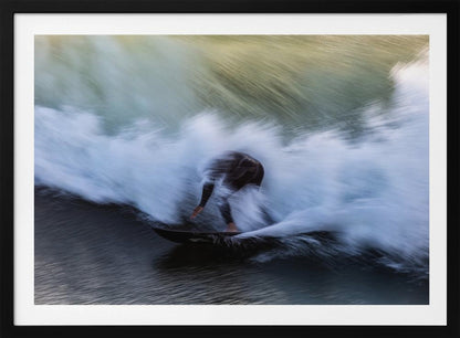 An abstract, motion-blur photograph of a surfer in a black wetsuit, crouched on their board and surrounded by a dynamic swirl of white sea spray and dark blue water, all enclosed in a silver frame. Artwork