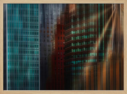 An abstract cityscape artwork in a silver frame, featuring a teal glass skyscraper on the left transitioning to red and brown buildings on the right with a strong vertical motion blur effect, creating a dynamic sense of movement. Decor