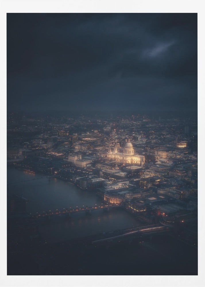 An atmospheric aerial view of London at night, with the illuminated St. Paul's Cathedral as the central focus. The sprawling cityscape glows with warm lights against a dark, stormy sky, while the River Thames flows in the foreground. Wall Art