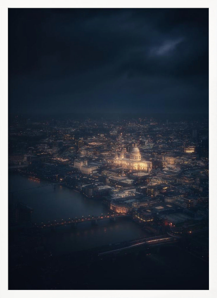 An atmospheric aerial view of London at night, with the illuminated St. Paul's Cathedral as the central focus. The sprawling cityscape glows with warm lights against a dark, stormy sky, while the River Thames flows in the foreground. Wall Art