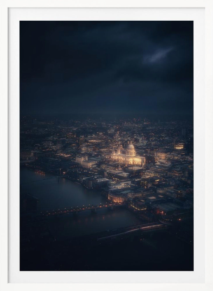 An atmospheric aerial view of London at night, with the illuminated St. Paul's Cathedral as the central focus. The sprawling cityscape glows with warm lights against a dark, stormy sky, while the River Thames flows in the foreground. Wall Art