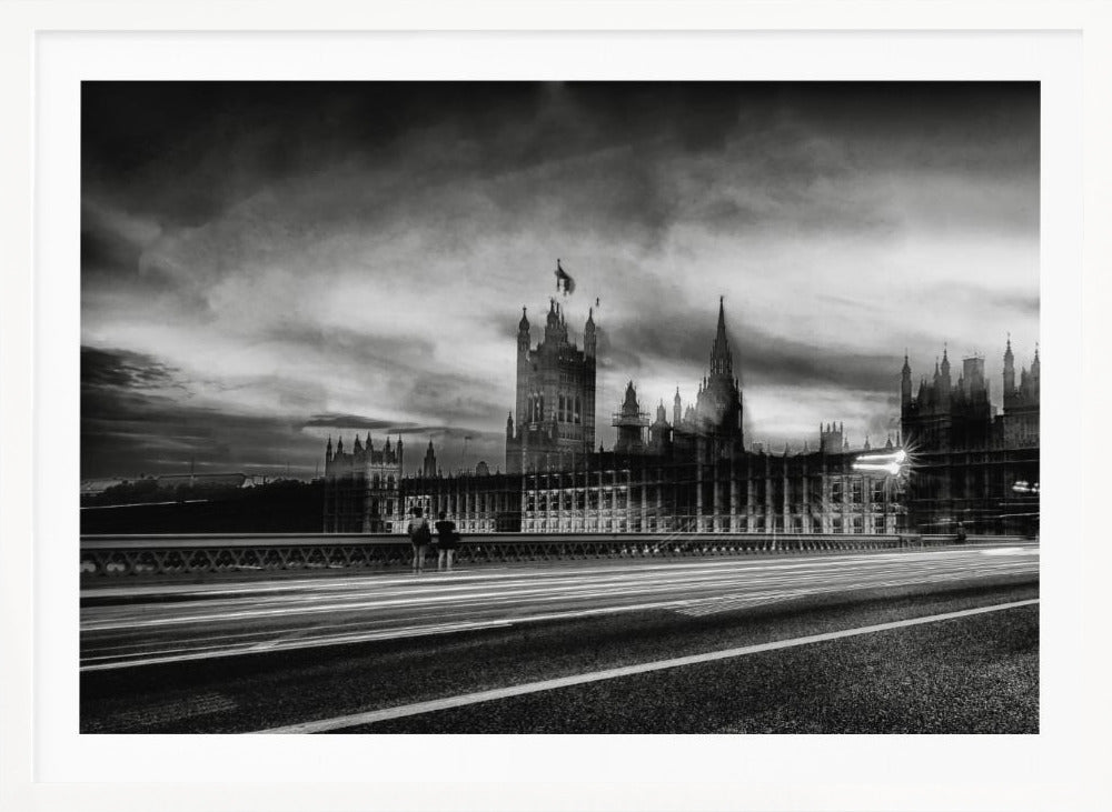A framed, black and white long-exposure photograph of the Houses of Parliament and Big Ben in London. The view is from a bridge, with streaks of white light from traffic blurring across the road in the foreground under a dramatic, cloudy sky. Wall Art