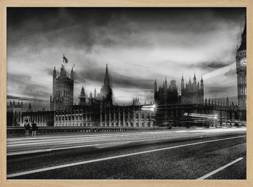 A framed, black and white long-exposure photograph of the Houses of Parliament and Big Ben in London. The view is from a bridge, with streaks of white light from traffic blurring across the road in the foreground under a dramatic, cloudy sky. Wall Art