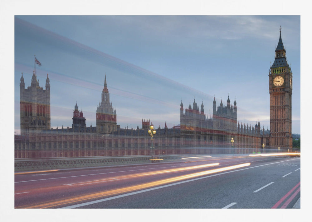 A framed, long-exposure photograph of London's Big Ben and the Houses of Parliament at dusk. In the foreground, streaks of red and yellow light from moving traffic blur across a bridge, creating a dynamic contrast with the historic architecture against a twilight sky. Decor