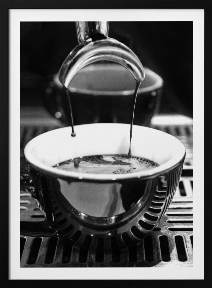 A close-up, black and white artistic photograph capturing the moment two streams of dark espresso pour from a portafilter into a waiting cup on a coffee machine's drip tray. Wall Art