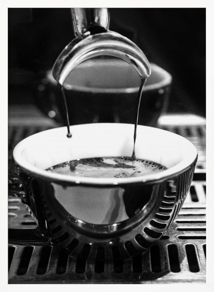 A close-up, black and white artistic photograph capturing the moment two streams of dark espresso pour from a portafilter into a waiting cup on a coffee machine's drip tray. Wall Art