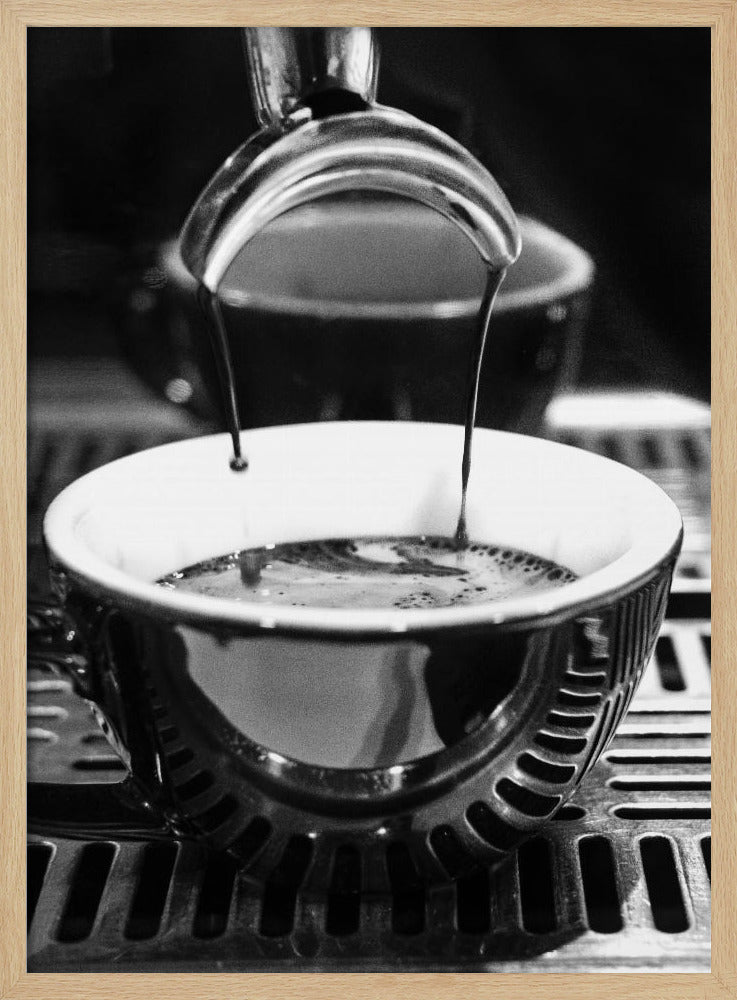 A close-up, black and white artistic photograph capturing the moment two streams of dark espresso pour from a portafilter into a waiting cup on a coffee machine's drip tray. Wall Art