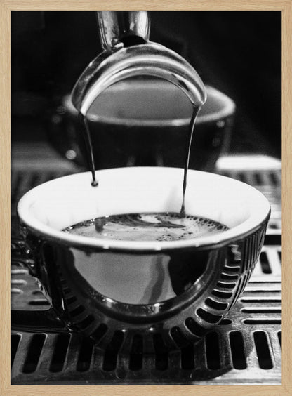 A close-up, black and white artistic photograph capturing the moment two streams of dark espresso pour from a portafilter into a waiting cup on a coffee machine's drip tray. Wall Art