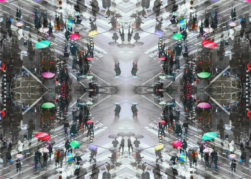 A symmetrical, kaleidoscopic abstract artwork created from an aerial view of a rainy city intersection. The mostly black and white image features pops of vibrant color from numerous umbrellas held by pedestrians crossing the street, all framed in a textured silver border. Artwork