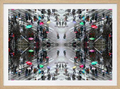 A symmetrical, kaleidoscopic abstract artwork created from an aerial view of a rainy city intersection. The mostly black and white image features pops of vibrant color from numerous umbrellas held by pedestrians crossing the street, all framed in a textured silver border. Artwork