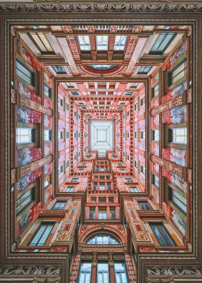 A symmetrical, worm's-eye view looking up through the center of an ornate, multi-story courtyard. The red and gold walls are covered in intricate details and frescoes, receding into the distance towards a square glass skylight. The entire artwork is presented within a decorative dark brown frame. Artwork