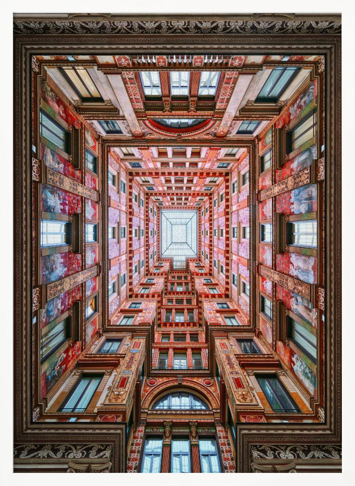 A symmetrical, worm's-eye view looking up through the center of an ornate, multi-story courtyard. The red and gold walls are covered in intricate details and frescoes, receding into the distance towards a square glass skylight. The entire artwork is presented within a decorative dark brown frame. Artwork