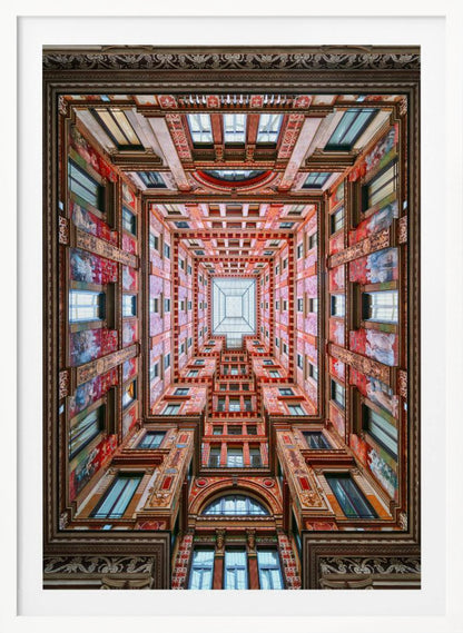 A symmetrical, worm's-eye view looking up through the center of an ornate, multi-story courtyard. The red and gold walls are covered in intricate details and frescoes, receding into the distance towards a square glass skylight. The entire artwork is presented within a decorative dark brown frame. Artwork