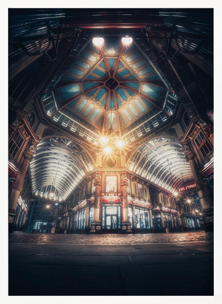 A dramatic, low-angle, wide shot of an empty Leadenhall Market at night. The ornate, domed ceiling is illuminated in blue and gold by bright, warm lights, which also cast a glow on the cobblestone floor and detailed Victorian storefronts. Wall Art