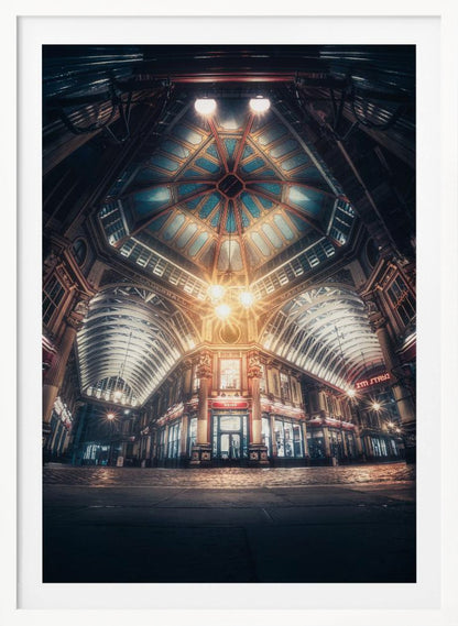 A dramatic, low-angle, wide shot of an empty Leadenhall Market at night. The ornate, domed ceiling is illuminated in blue and gold by bright, warm lights, which also cast a glow on the cobblestone floor and detailed Victorian storefronts. Wall Art