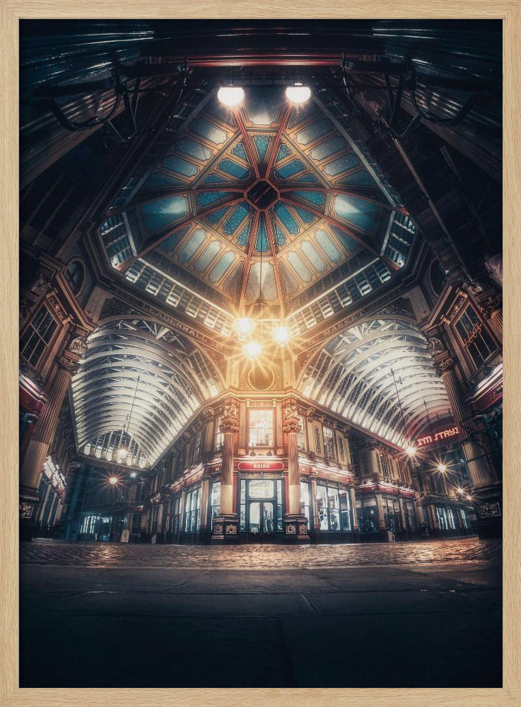 A dramatic, low-angle, wide shot of an empty Leadenhall Market at night. The ornate, domed ceiling is illuminated in blue and gold by bright, warm lights, which also cast a glow on the cobblestone floor and detailed Victorian storefronts. Wall Art