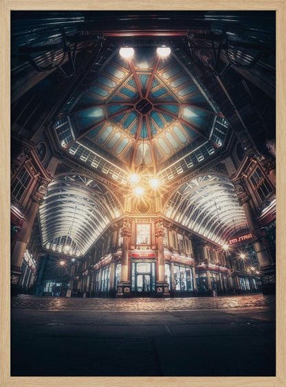 A dramatic, low-angle, wide shot of an empty Leadenhall Market at night. The ornate, domed ceiling is illuminated in blue and gold by bright, warm lights, which also cast a glow on the cobblestone floor and detailed Victorian storefronts. Wall Art