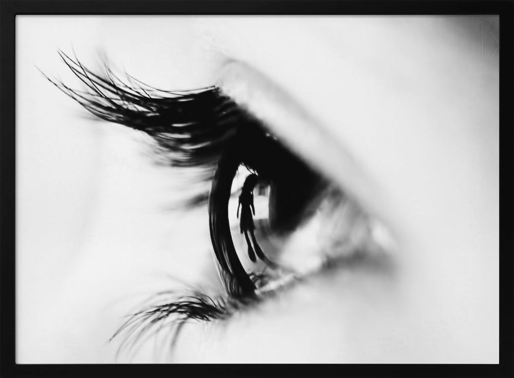 A dramatic black and white macro photograph of a human eye in profile, with a surreal reflection of a person's silhouette visible in the pupil. Print