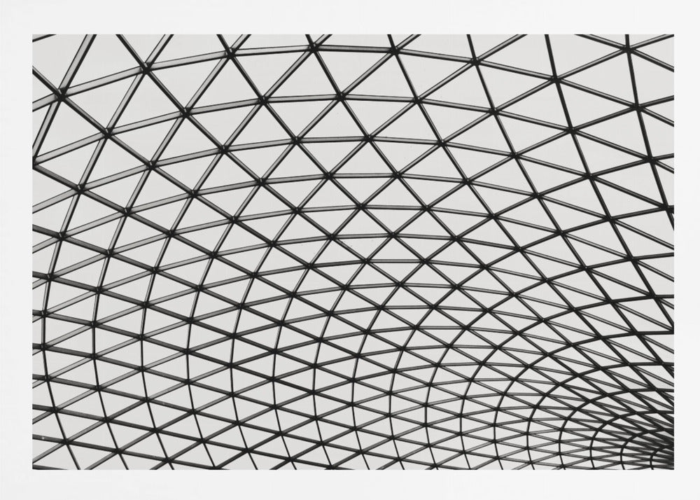 A framed, black and white photograph of a modern architectural dome ceiling. The image is a close-up, looking up at the intricate metal framework that creates a repeating pattern of triangles against the bright glass panels. Poster