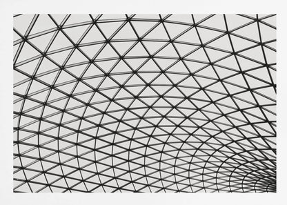 A framed, black and white photograph of a modern architectural dome ceiling. The image is a close-up, looking up at the intricate metal framework that creates a repeating pattern of triangles against the bright glass panels. Poster