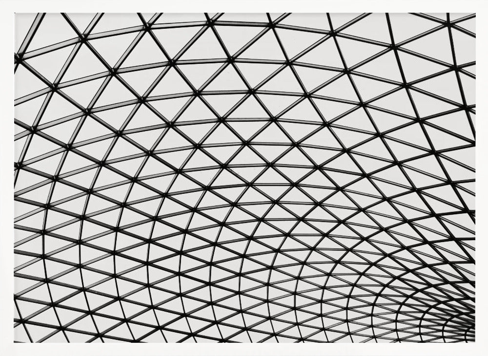 A framed, black and white photograph of a modern architectural dome ceiling. The image is a close-up, looking up at the intricate metal framework that creates a repeating pattern of triangles against the bright glass panels. Poster