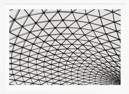 A framed, black and white photograph of a modern architectural dome ceiling. The image is a close-up, looking up at the intricate metal framework that creates a repeating pattern of triangles against the bright glass panels. Poster