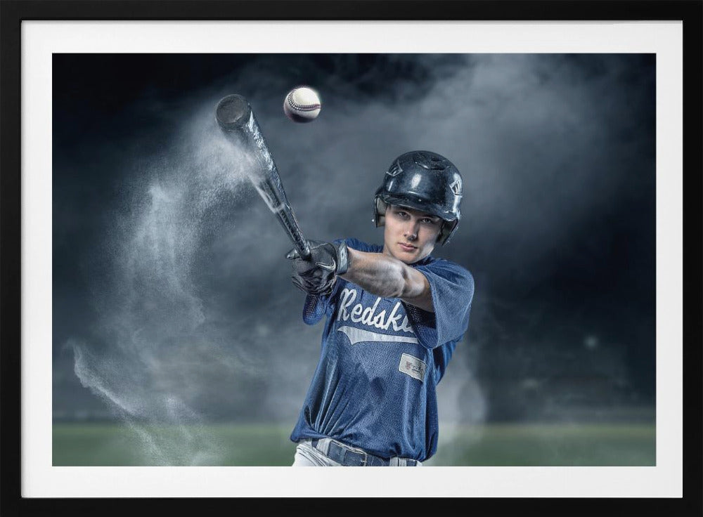 A dramatic, framed portrait of a young baseball player in a blue jersey and helmet, captured in the moment of hitting a baseball, with a cloud of dust exploding from the bat against a dark, smoky background. Poster