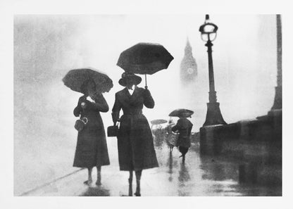 A vintage black and white photograph of people with umbrellas walking on a wet, foggy day in London. The silhouettes of the people are dark against the misty background, where the faint outline of Big Ben and a street lamp are visible. Wall Art