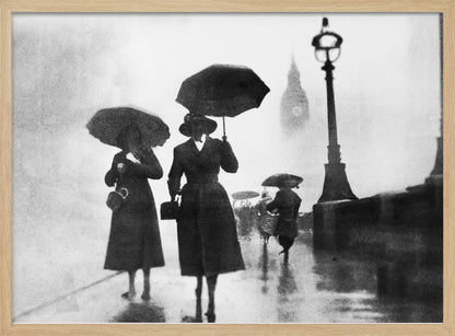A vintage black and white photograph of people with umbrellas walking on a wet, foggy day in London. The silhouettes of the people are dark against the misty background, where the faint outline of Big Ben and a street lamp are visible. Wall Art
