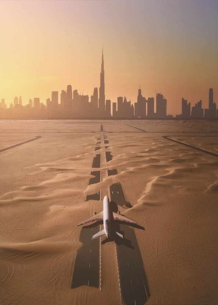 A surreal high-angle view of a white airplane on a runway partially buried in desert sand, pointing towards the Dubai city skyline during a hazy orange sunset. Decor