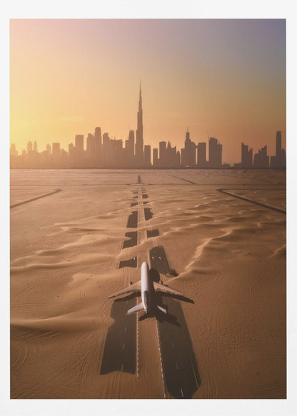 A surreal high-angle view of a white airplane on a runway partially buried in desert sand, pointing towards the Dubai city skyline during a hazy orange sunset. Decor