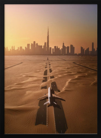 A surreal high-angle view of a white airplane on a runway partially buried in desert sand, pointing towards the Dubai city skyline during a hazy orange sunset. Decor