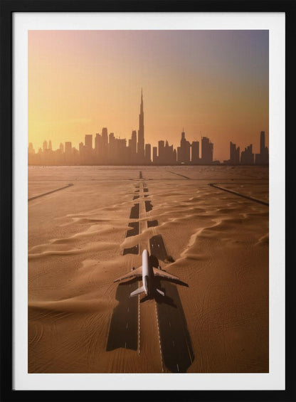 A surreal high-angle view of a white airplane on a runway partially buried in desert sand, pointing towards the Dubai city skyline during a hazy orange sunset. Decor