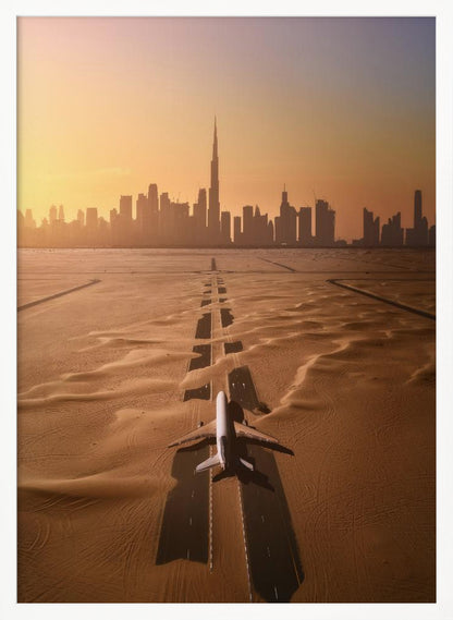 A surreal high-angle view of a white airplane on a runway partially buried in desert sand, pointing towards the Dubai city skyline during a hazy orange sunset. Decor