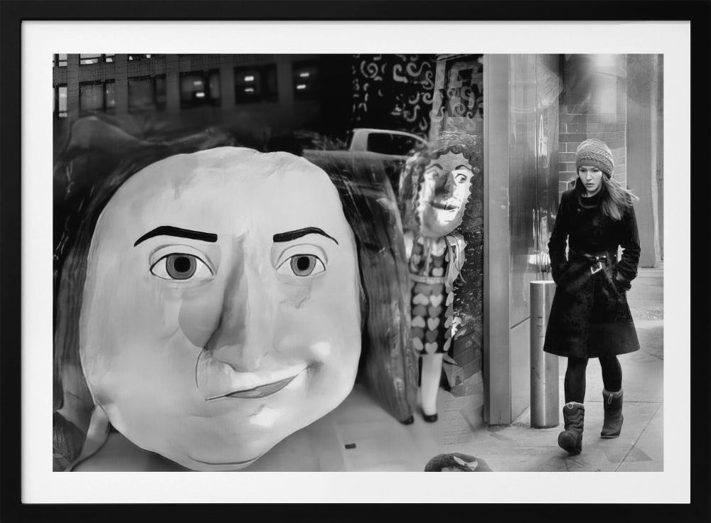 A surreal black and white photograph with a silver frame, featuring a giant, cartoonish head of a historical figure reflected in a window, juxtaposed with a young woman in a winter coat and beanie walking down a city sidewalk. Wall Art