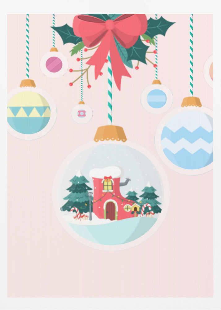 A festive Christmas illustration featuring hanging ornaments against a soft pink background. A large central ornament depicts a charming winter scene with a red, boot-shaped house covered in snow, nestled among pine trees. Other colorful, patterned baubles hang from striped strings, all under a large red bow with holly. Decor