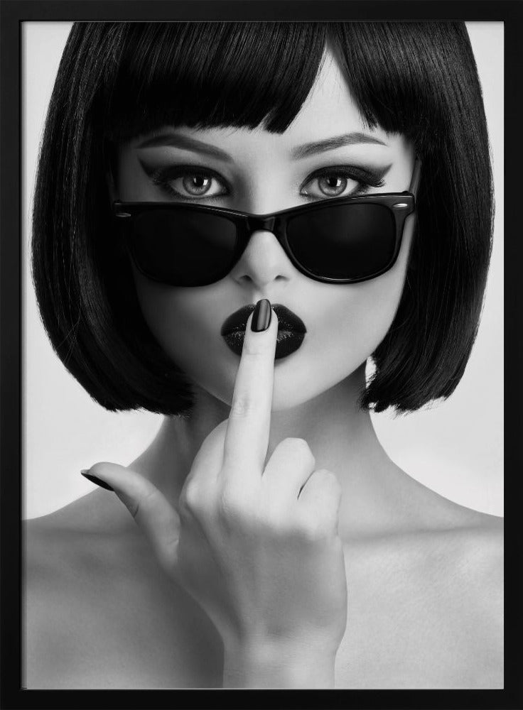 A striking black and white portrait of a woman with a sharp bob haircut, sunglasses, and bold makeup. She holds one finger with a black-painted nail up to her dark lips, making a 'shushing' gesture. Poster