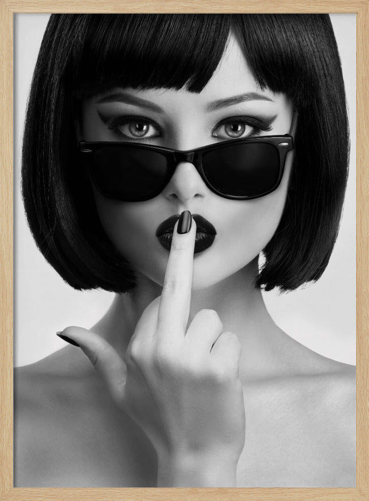 A striking black and white portrait of a woman with a sharp bob haircut, sunglasses, and bold makeup. She holds one finger with a black-painted nail up to her dark lips, making a 'shushing' gesture. Poster
