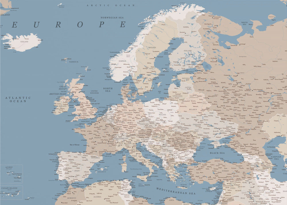 A detailed, framed map of Europe with a muted color palette. The oceans and seas are a soft blue, while the countries are various shades of beige and tan. Text labels for countries, cities, and bodies of water are clearly visible across the map. The map is housed in a simple silver-gray frame. Poster