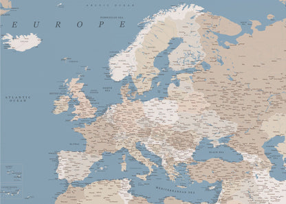 A detailed, framed map of Europe with a muted color palette. The oceans and seas are a soft blue, while the countries are various shades of beige and tan. Text labels for countries, cities, and bodies of water are clearly visible across the map. The map is housed in a simple silver-gray frame. Poster