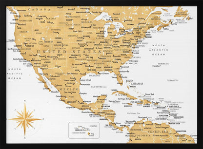 A stylized map of North and Central America and the Caribbean, featuring gold-colored landmasses on a light gray, textured background. Countries, states, and major cities are labeled in black text. A compass rose is shown in the lower-left corner. The entire map is enclosed in a light gray frame. Decor