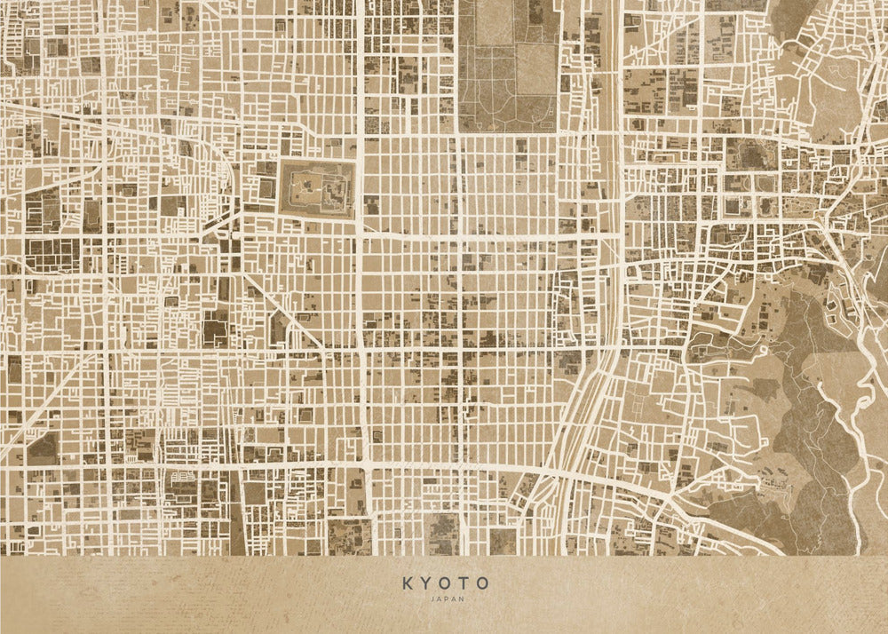 A framed, stylized map of Kyoto, Japan, in shades of brown and beige. The city streets are illustrated as a complex grid of off-white lines against a textured brown background. At the bottom, a solid beige banner contains the text 'KYOTO' and 'JAPAN' in a modern sans-serif font. The artwork is surrounded by a brushed silver frame. Artwork
