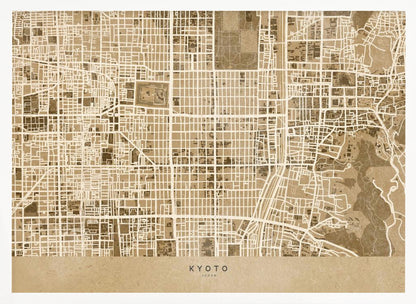 A framed, stylized map of Kyoto, Japan, in shades of brown and beige. The city streets are illustrated as a complex grid of off-white lines against a textured brown background. At the bottom, a solid beige banner contains the text 'KYOTO' and 'JAPAN' in a modern sans-serif font. The artwork is surrounded by a brushed silver frame. Artwork