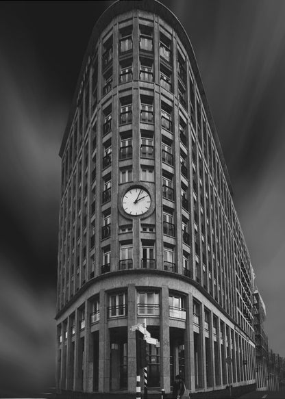 A dramatic low-angle, black and white photograph of a large, curved corner building with a prominent clock on its facade. The sky is dark with a motion blur effect, making the building appear grand and imposing. Artwork