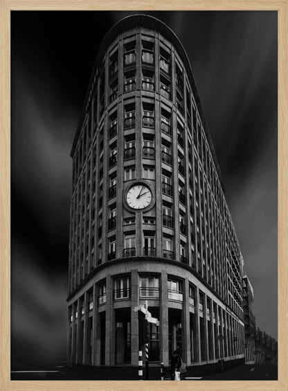A dramatic low-angle, black and white photograph of a large, curved corner building with a prominent clock on its facade. The sky is dark with a motion blur effect, making the building appear grand and imposing. Artwork